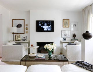 white living room with tv on wall