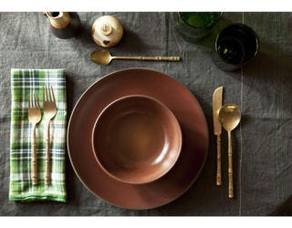table setting with bronze flatware, green plaid napkin, and brown coupe dishes
