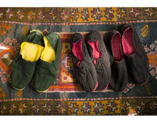 colorful chinese slippers on vintage rug