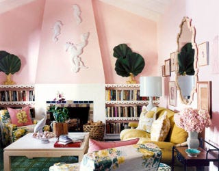 pink painted living room with green carpet and fireplace