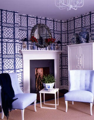 Fireplace and blue chairs in dressing room.