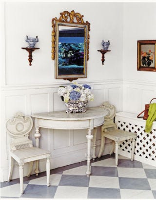 white entryway with table and chairs
