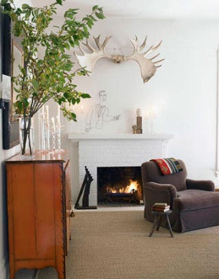 sitting area with antlers hanging over the fireplace