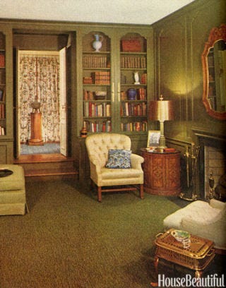 living room with dark green walls and built in bookcase