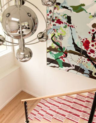 vintage chandelier over stairway with painting