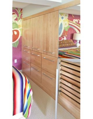 wall of wooden cabinets in colorful bedroom