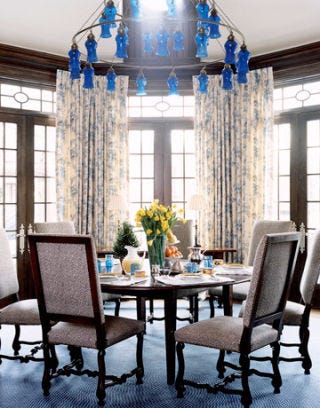 blue and white breakfast room, dining room with blue chandelier and blue carpet