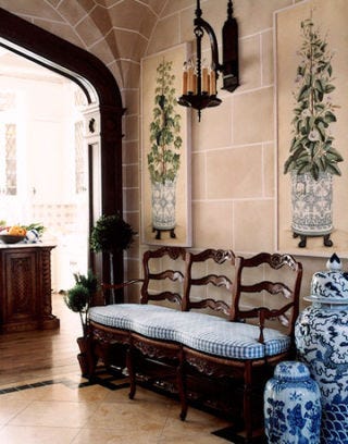 hallway with settee and blue and white porcelain urns and wall paintings