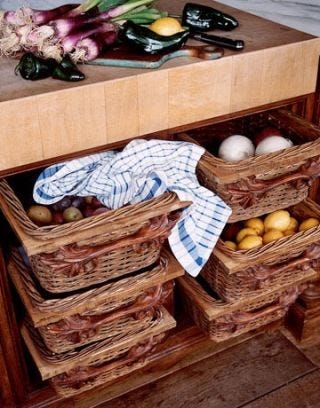 kitchen island with wooden chopping block and basket drawers