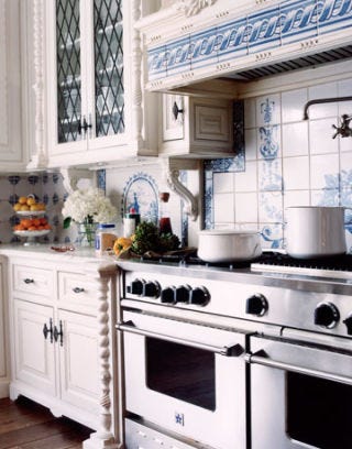 blue and white kitchen with large stainless steal oven and stove