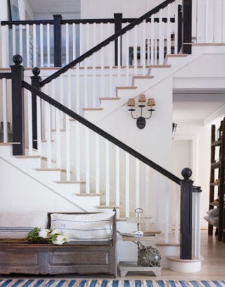 stairway in entryway with black banister
