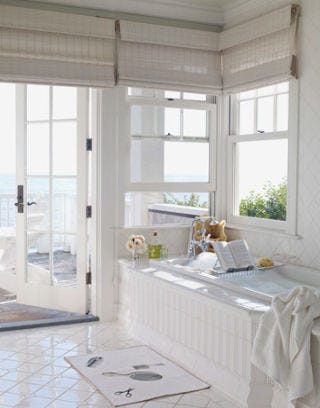 white bathroom with deck facing the ocean