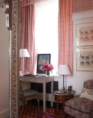 pink bedroom with a vanity in front of window