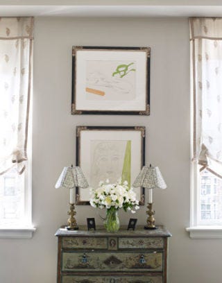etchings hang above commode in master bedroom
