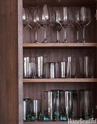 interior view of walnut cabinets holding wine glasses