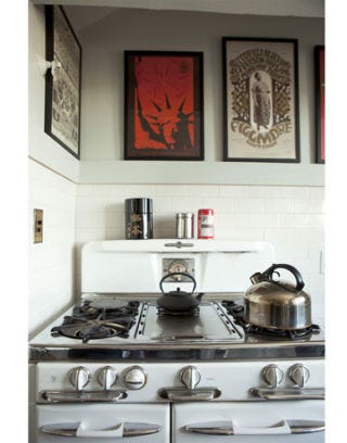 vintage stove with vintage posters hanging above it