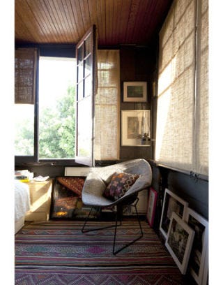 sleeping porch guest room with open window and diamond chair