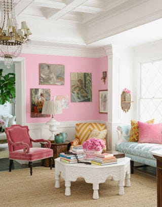 pink living room with white table and beige carpet