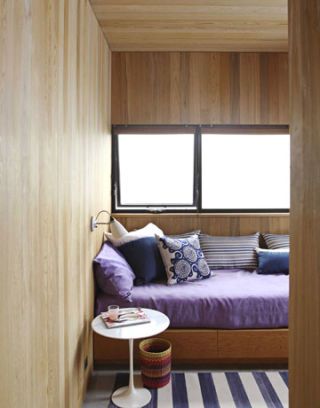 a daybed in wood-walled room