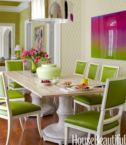 room with green chairs and green pattern wallpaper