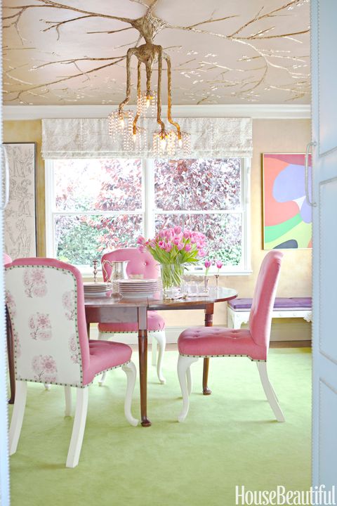 dining room with pink chairs and green floor