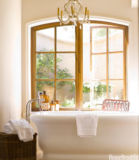 white tub sitting beneath window