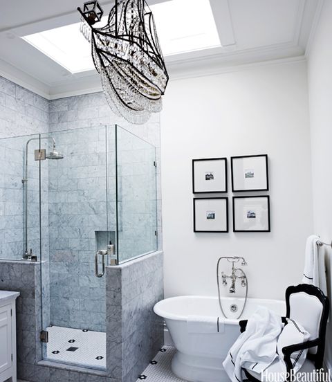 master bathrom with black white tiles and also a crystal chandelier