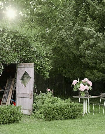 table and chairs next to a shed