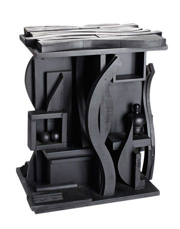 black wooden table with abstract details inspired by louise nevelson art