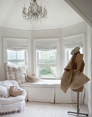 a white window bench in front of a window