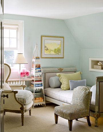 the small room with a daybed and a seating area