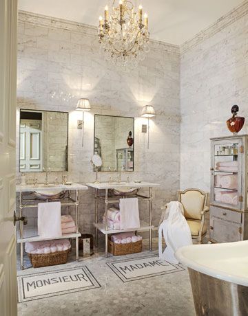 a chandelier hanging over an antique bathroom