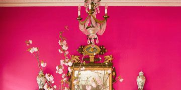 hot pink foyer with table mirror and black and white swirl chair