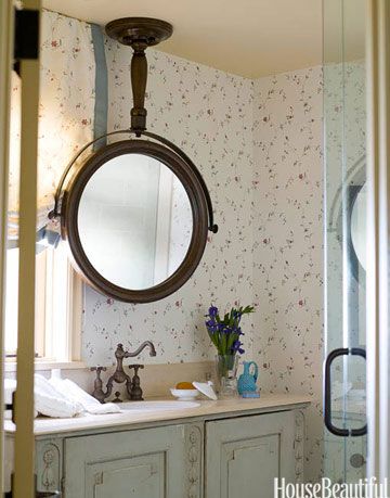 mirror hanging from the ceiling in a bathroom