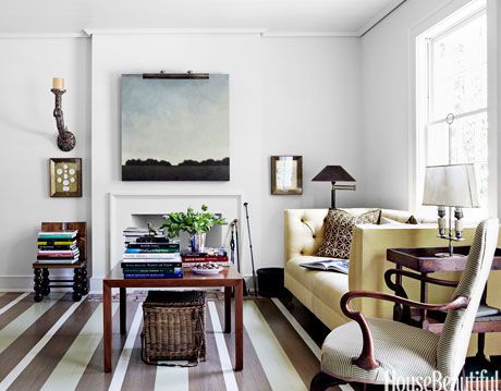 room with white walls and striped wood floor