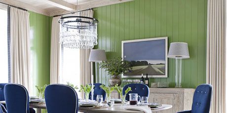 a blue and green dining room with a whitewashed table
