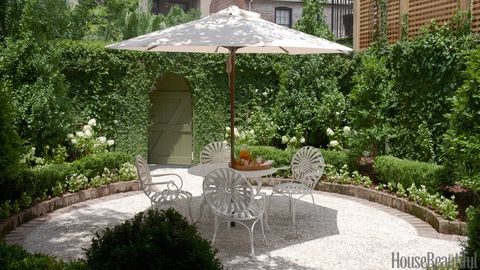 table with umbrella and chairs in garden