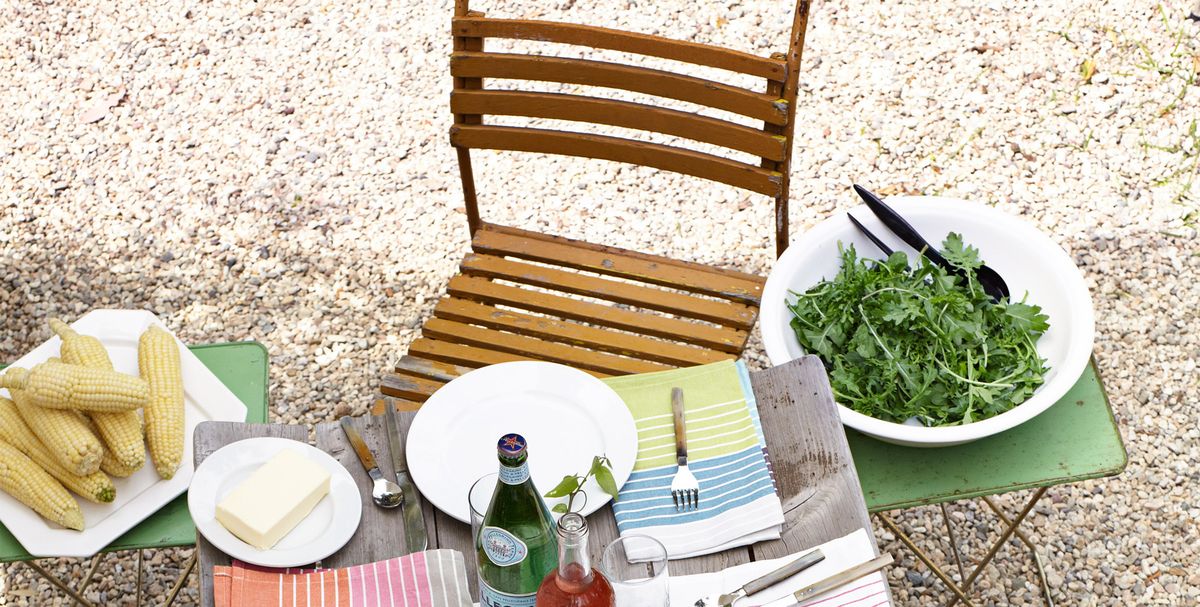 an outdoor table set with colorful striped italian linens