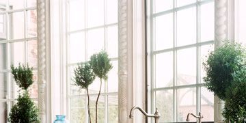 white kitchen with copper sink and nickel faucet