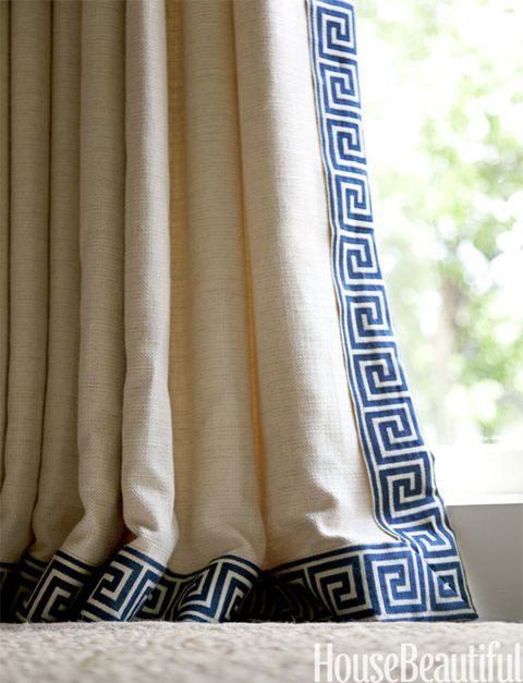 blue greek key border on a tan curtain