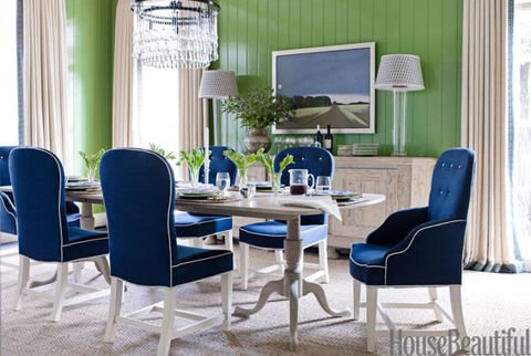 dining area with green walls and a blue bench