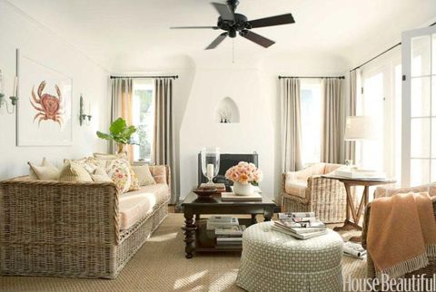 living room with ceiling fan and coral colors and wicker furniture