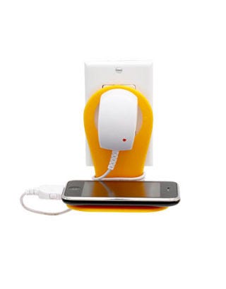 plastic orange piece hung over phone charger that is plugged into outlet