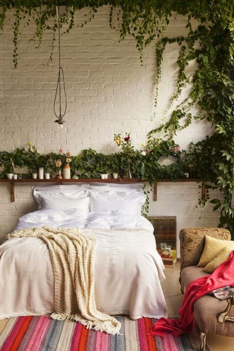 A minimal bedroom feels au naturale with leafy decor—whether it's hanging from the walls or in the form of a tiny plant.