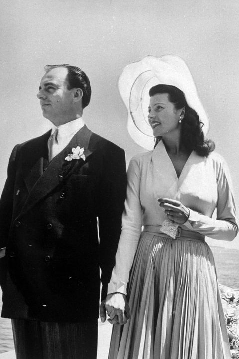 Prince Aly Khan w. his 2nd wife, actress, Rita Hayworth posing at seaside in their wedding clothes after ceremony, France.  (Photo by Nat Farbman/The LIFE Picture Collection/Getty Images)