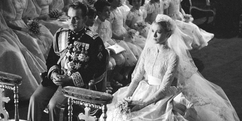 Prince Rainier of Monaco and American actress Grace Kelly (1929 - 1982) sit before the altar during their wedding ceremony at the Cathedral of Saint Nicholas, Monte Carlo, Monaco, April 19, 1956. Kelly's gown was designed by costume designer Helen Rose. (Photo by Thomas McAvoy/The LIFE Picture Collection/Getty Images)