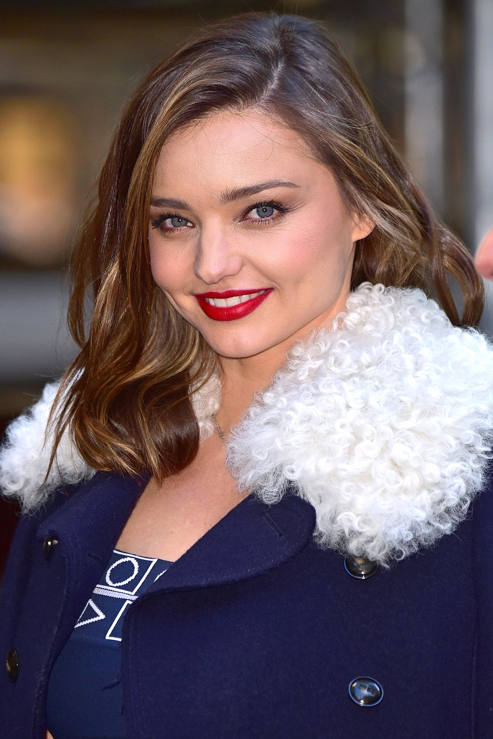 <p>Red lipstick and a statement coat say seasoned pro.</p>