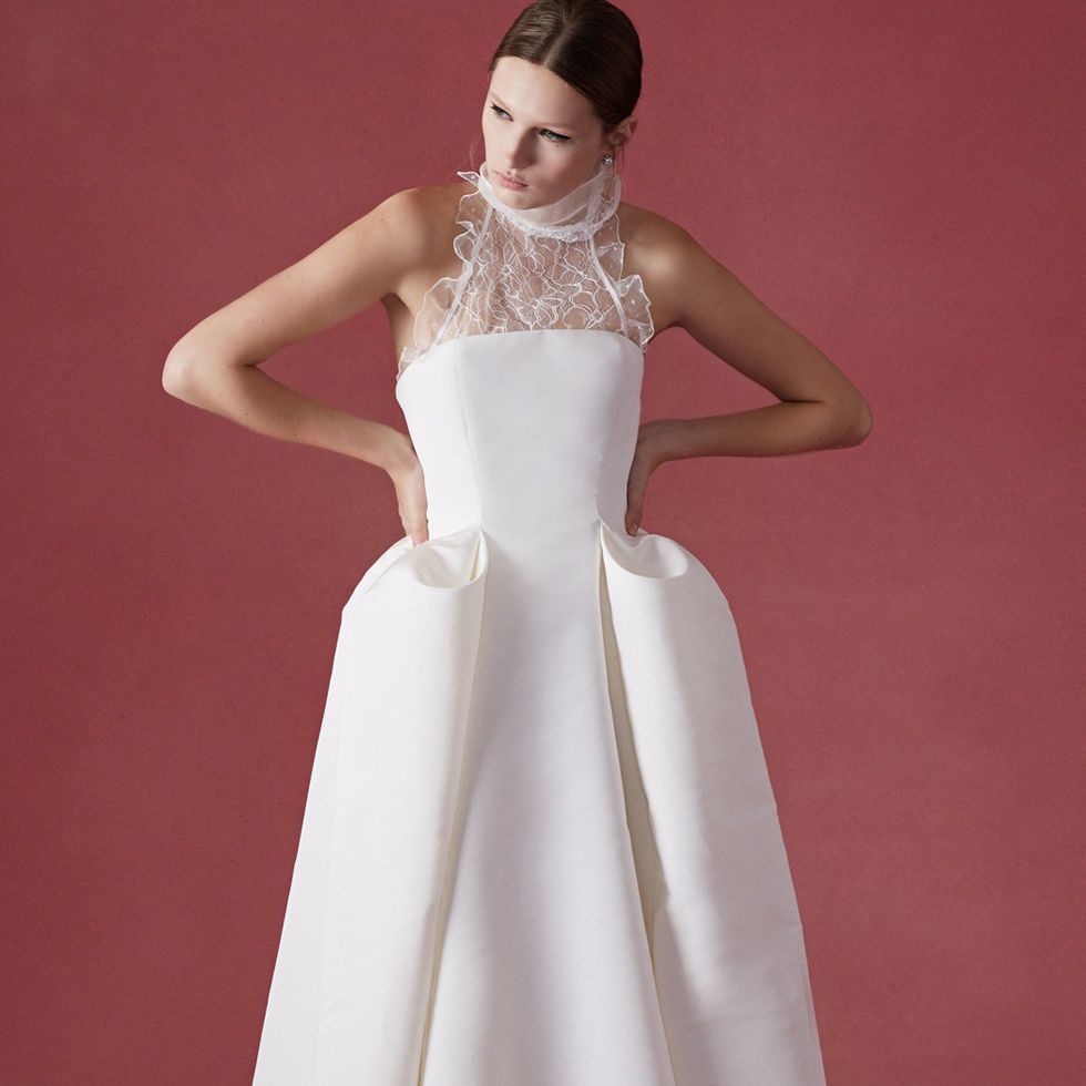 View of a white lace wedding dress exhibited in the Balenciaga