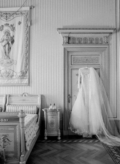<p>The bride's <a href="https://www.moniquelhuillier.com/">Monique Lhuillier</a> gown and veil hanging in her dressing suite. "I found the dress at <a href="http://www.brownsbride.com/">Browns Bride</a> in London. I loved the duality of it: the beading was both traditional and modern with its floral motifs and geometric embroidery. It had an overskirt, so it was actually two dresses in one. I wore the overskirt for the ceremony with my veil, then took both of them off for the cocktail reception and party."</p>