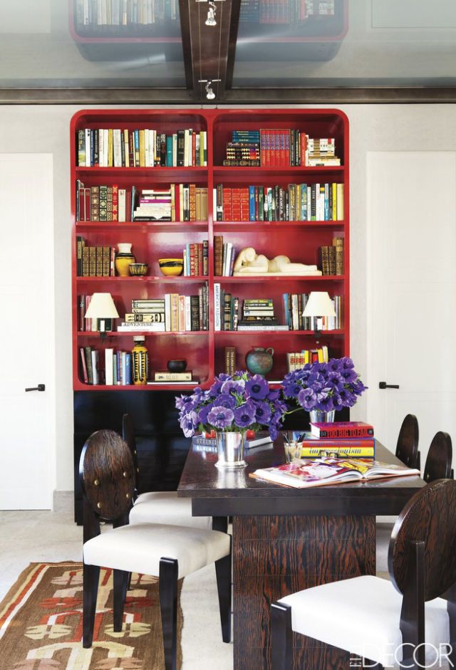 <p>The library of a <a href="http://www.elledecor.com/design-decorate/room-ideas/g1440/bunny-williams-transforms-a-park-avenue-penthouse/" target="_blank">Manhattan penthouse designed by Bunny Williams</a> doubles as a guest room; a remote control-operated bed slides out from the base of the custom-made red-lacquered bookcase. The table and chairs are by André Sornay. </p>